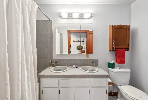 a front view of a house with yard and green space