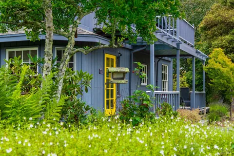 a house with lots of trees in the background