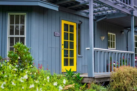 a living room with furniture and a book shelf