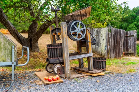 a kitchen with a refrigerator a stove a sink dishwasher and wooden cabinets with wooden floor