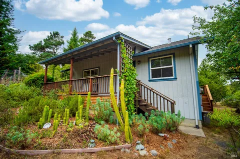 a kitchen with a table chairs sink and cabinets
