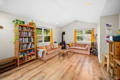 a bedroom with furniture and a wooden floor