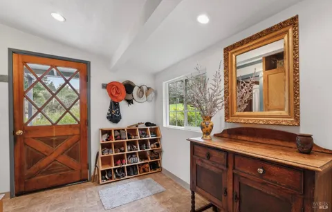 a dining room with furniture window and wooden floor