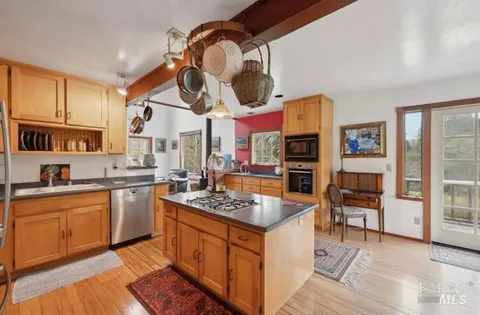 a kitchen with a stove a sink and a refrigerator