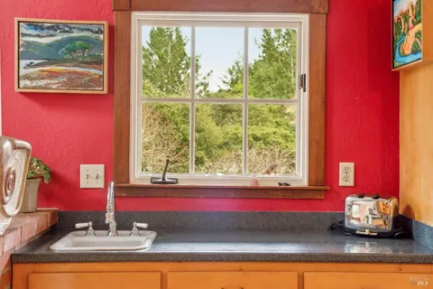 a living room with furniture a window and a chandelier