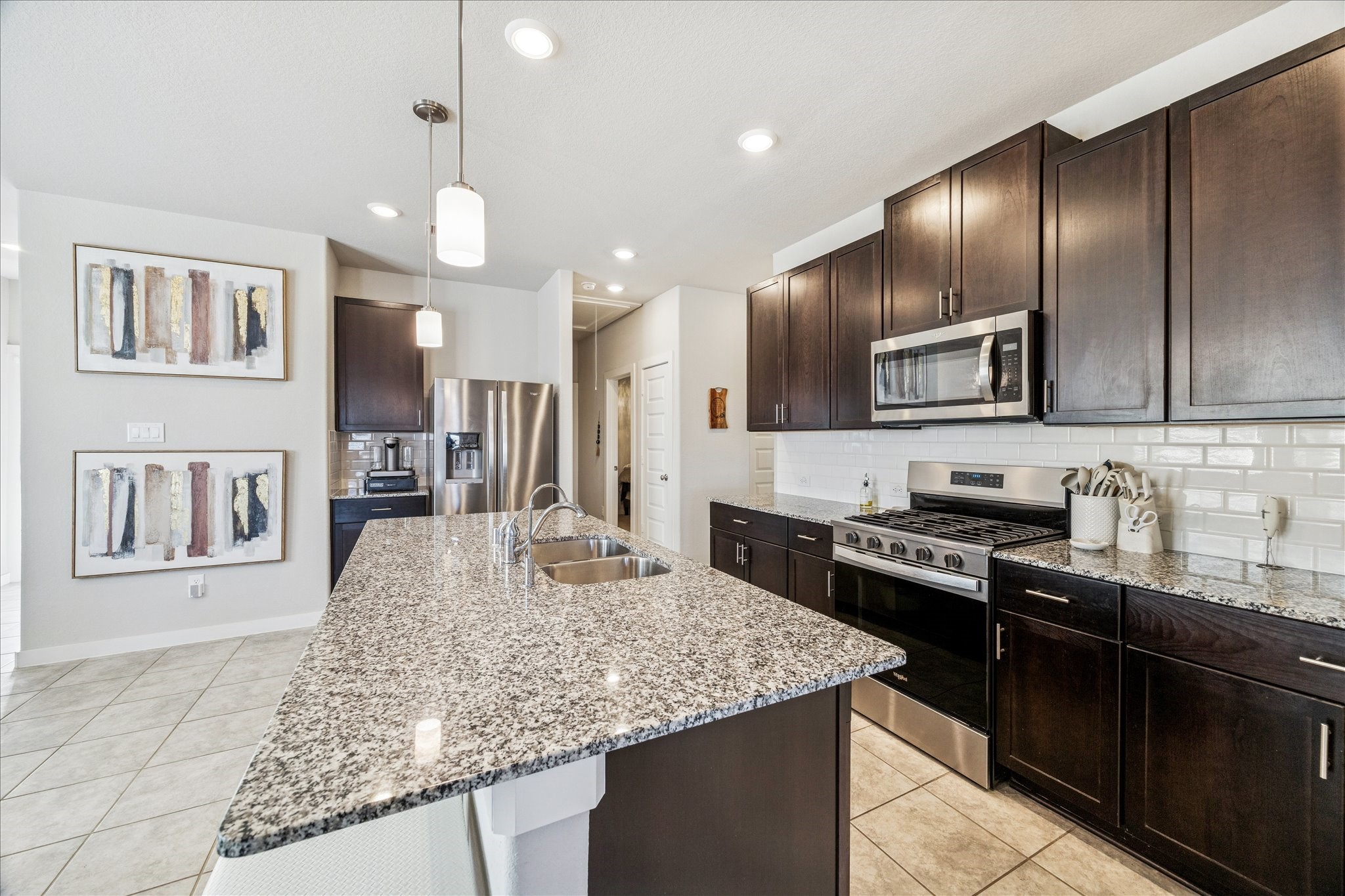 5547 Madden Lane Houston, TX 77048 - Photo 17 of 20 a kitchen with stainless steel appliances granite countertop a sink stove and refrigerator