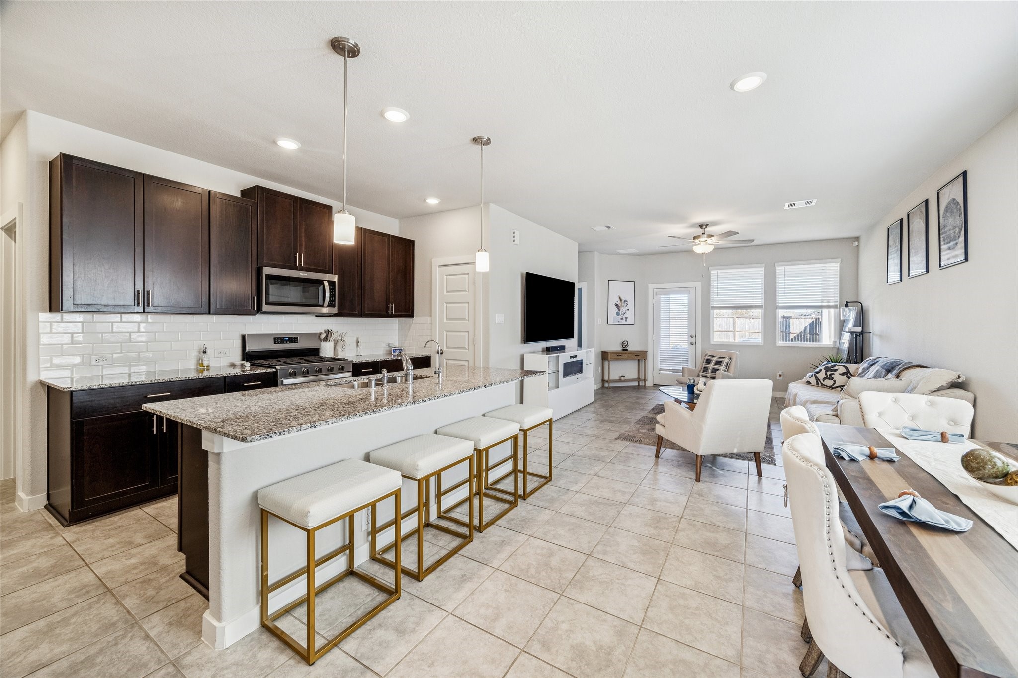 5547 Madden Lane Houston, TX 77048 - Photo 3 of 20 a large white kitchen with stainless steel appliances granite countertop a sink and cabinets