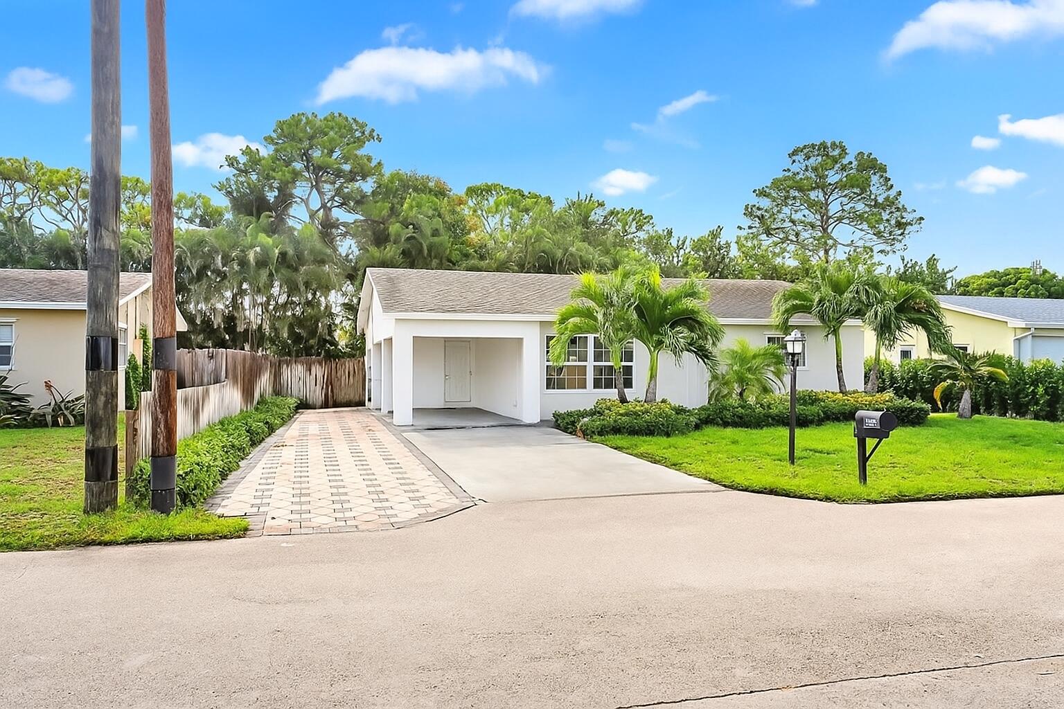 a view of a house with a yard and tree s