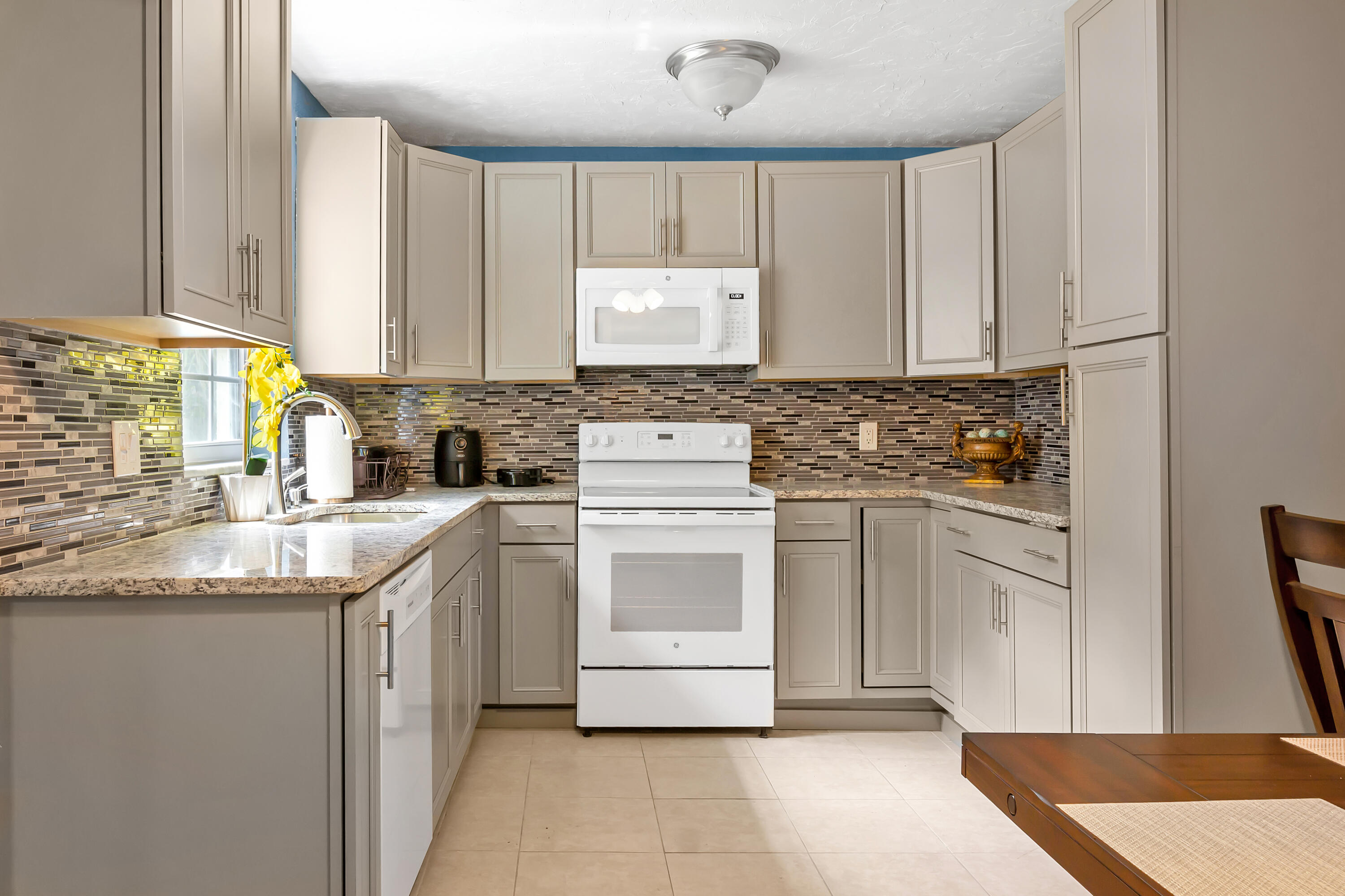 4340 Wilkinson Drive Lake Worth, FL 33461 - Photo 7 of 12 a kitchen with cabinets appliances and a counter top space