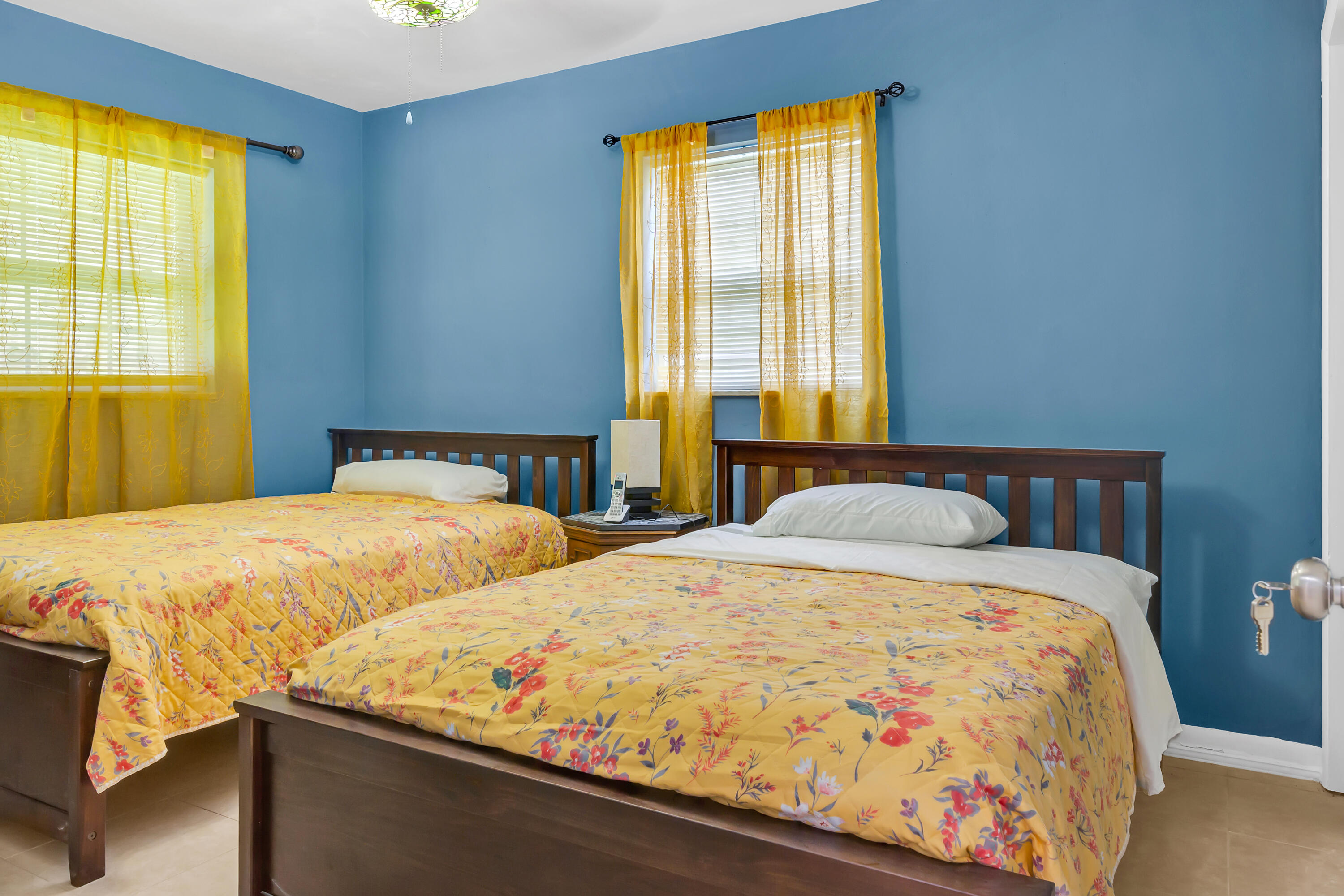 4340 Wilkinson Drive Lake Worth, FL 33461 - Photo 8 of 12 a bed sitting in a bedroom next to a window