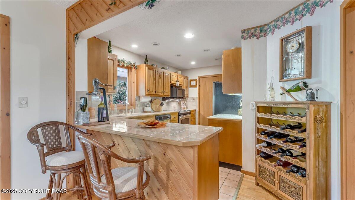 297 Forest Drive Canadensis, PA 18325 - Photo 12 of 58 a kitchen with stainless steel appliances kitchen island granite countertop a table and chairs