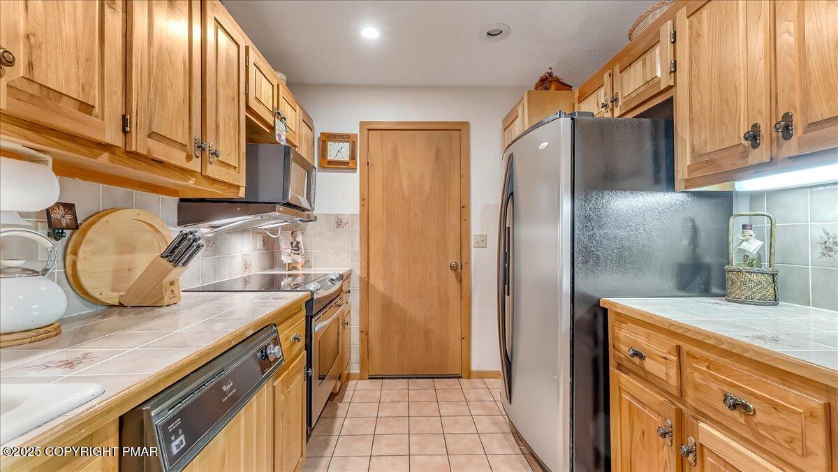 297 Forest Drive Canadensis, PA 18325 - Photo 14 of 58 a kitchen with stainless steel appliances granite countertop a sink and a refrigerator