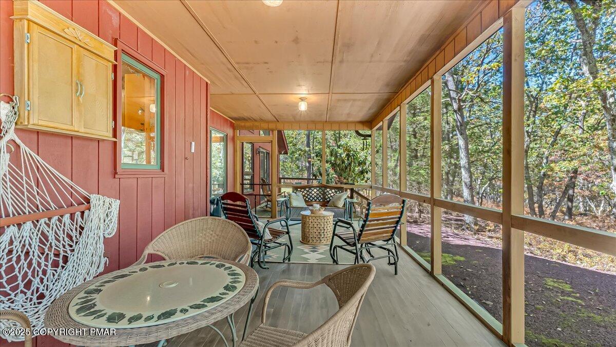297 Forest Drive Canadensis, PA 18325 - Photo 19 of 58 a dining room with furniture large windows and wooden floor