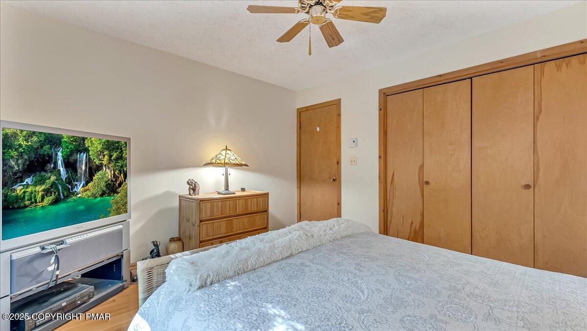 297 Forest Drive Canadensis, PA 18325 - Photo 22 of 58 a bedroom with a bed and a chandelier