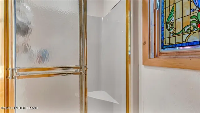 a view of a hallway with entryway wooden floor and front door