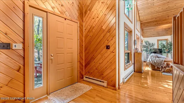 a bedroom with a bed and dresser with mirror