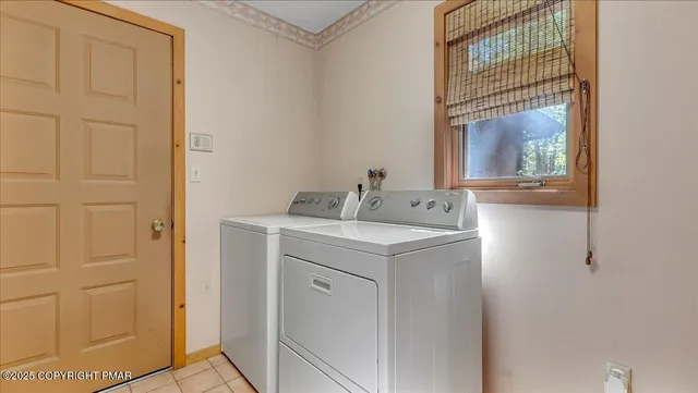 a view of a wooden chairs and a table in the back yard