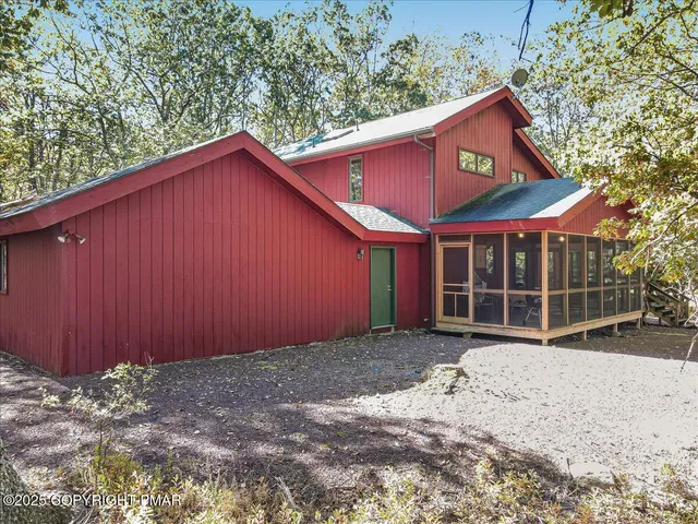 a street sign on a sidewalk next to a road