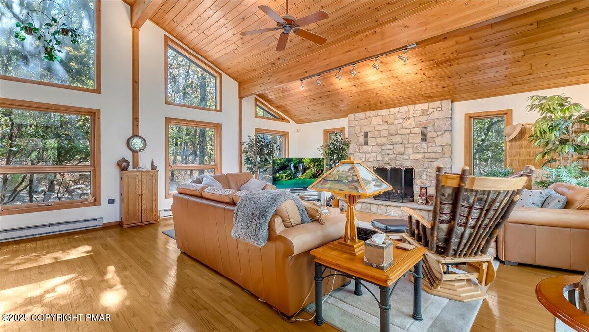 297 Forest Drive Canadensis, PA 18325 - Photo 7 of 58 a living room with fireplace furniture and a large window