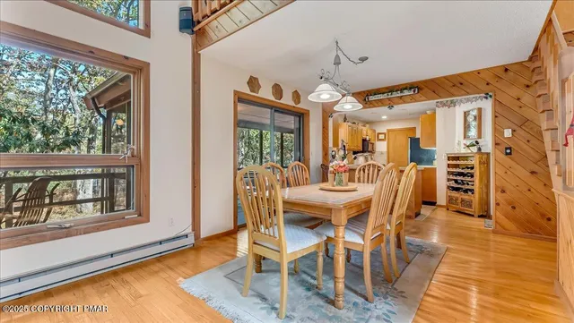 a dining room with furniture and wooden floor