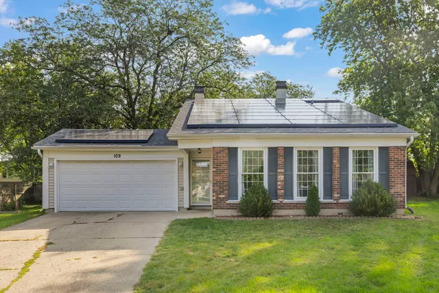front view of a house with a garden