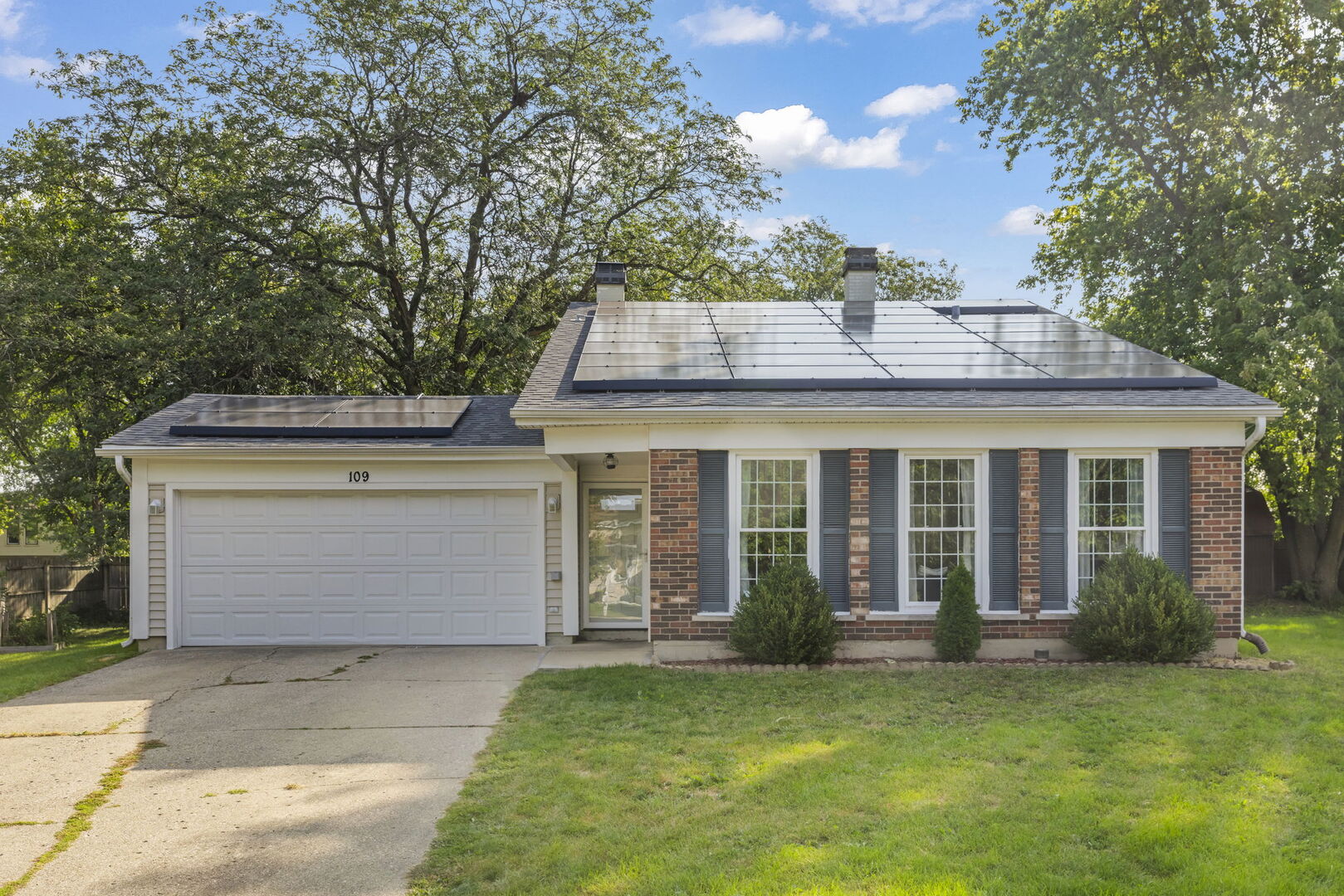 front view of a house with a garden