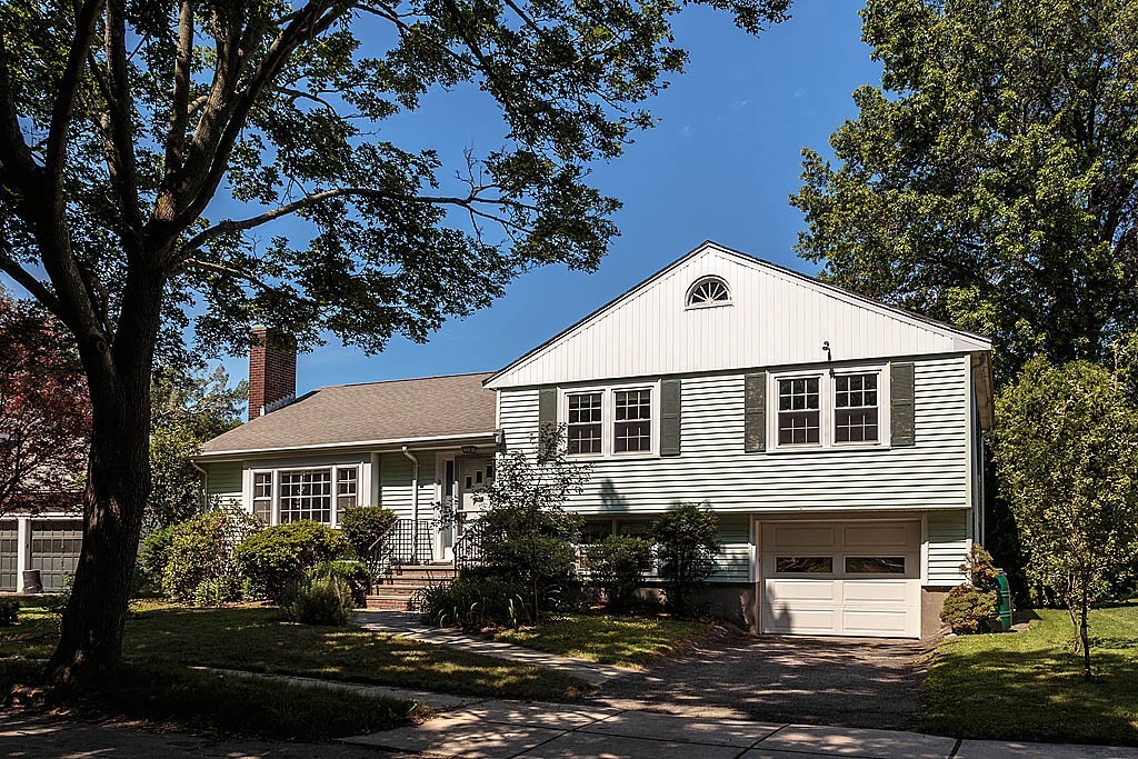 75 Taylor Road Belmont, MA 02478 - Photo 1 of 17 a front view of a house with garden
