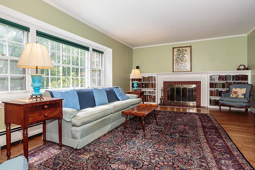 75 Taylor Road Belmont, MA 02478 - Photo 2 of 17 a living room with furniture a large window and a fireplace