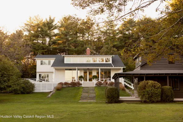 a front view of a house with a garden
