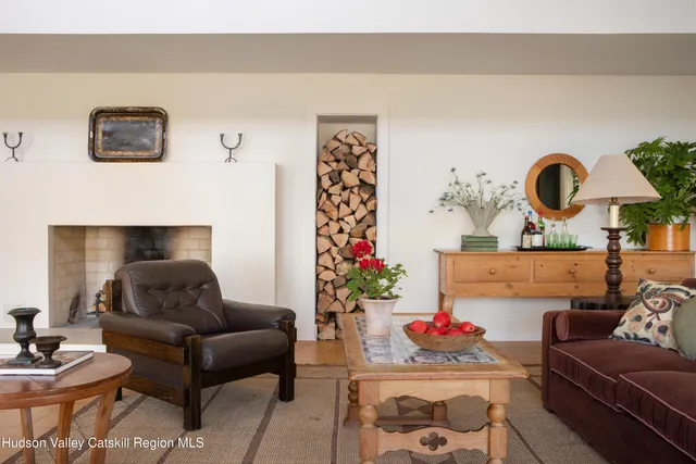 a living room with furniture and flowers