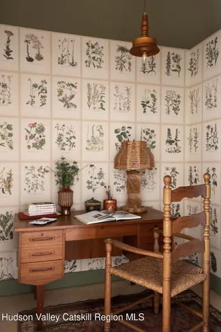 a living room with furniture and a painting on the wall