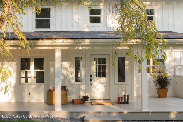 a front view of a house with outdoor seating