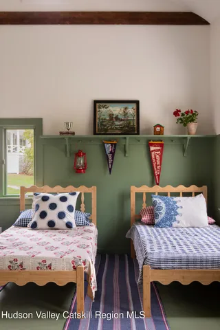 a view of a backyard with table and chairs and a large tree