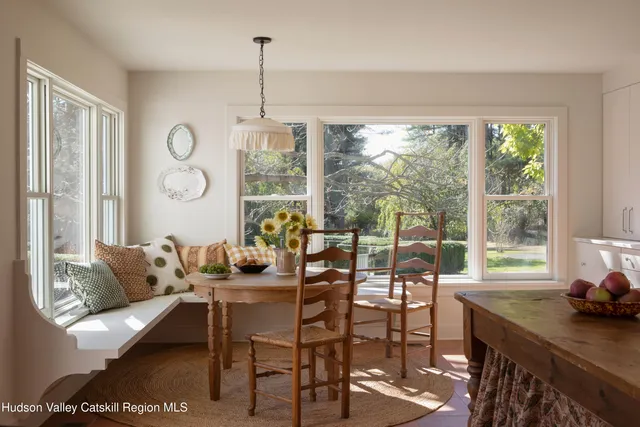 a dining room with furniture and a window