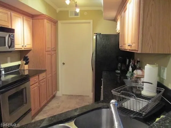 a kitchen with a stove and a refrigerator