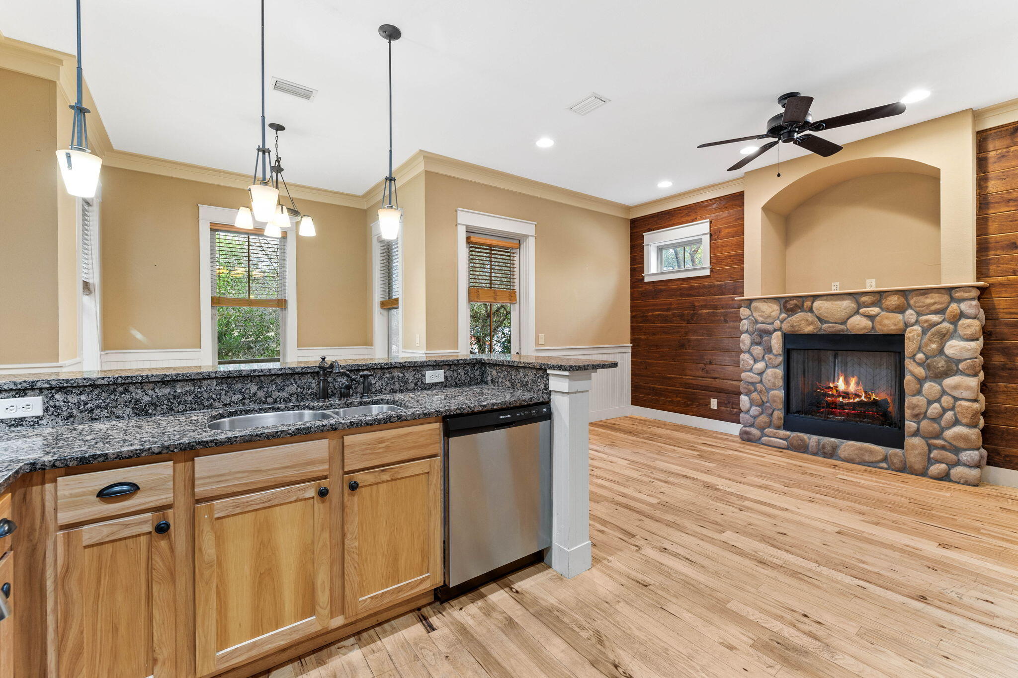 8 Gulf Mark Lane Santa Rosa Beach, FL 32459 - Photo 14 of 44 a kitchen with wooden floor and a fireplace