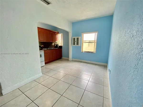 a living room with a couch and a stove top oven