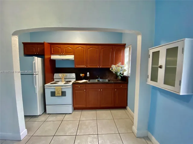 a kitchen with a refrigerator and a stove