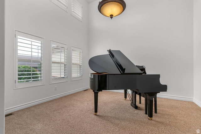 439 East 13540 South Draper, UT 84020 - Photo 2 of 46 Room featuring vaulted ceiling, three windows with plantation shutters, additional high windows with plantation shutters, and carpet flooring