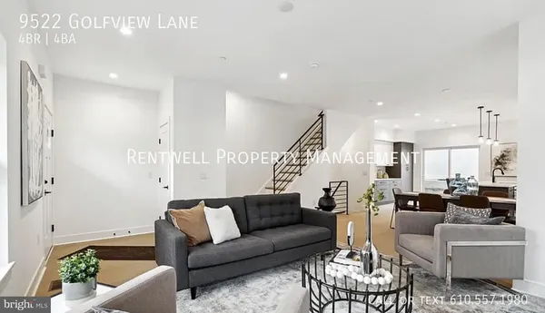 a living room with furniture kitchen view and a chandelier