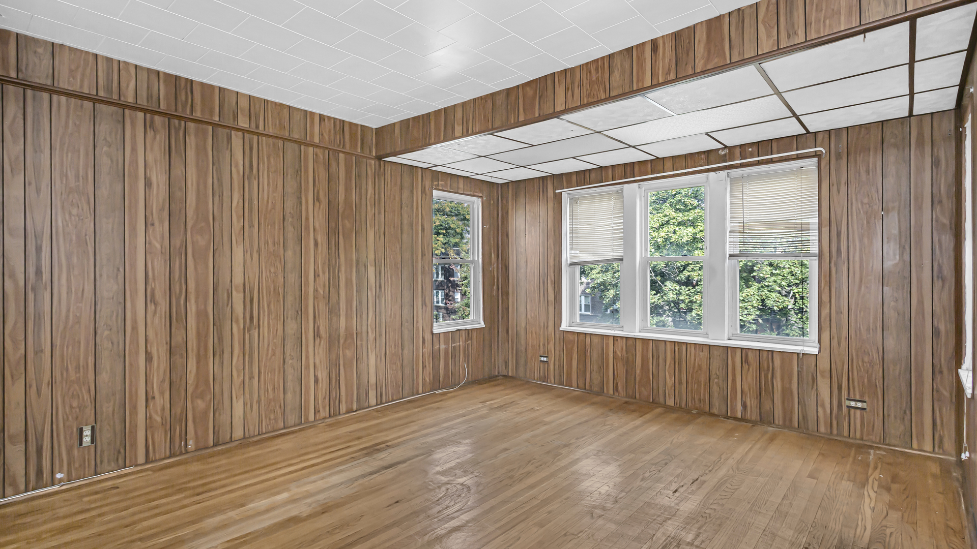 1712 North Monitor Avenue Chicago, IL 60639 - Photo 13 of 33 an empty room with wooden floor and windows