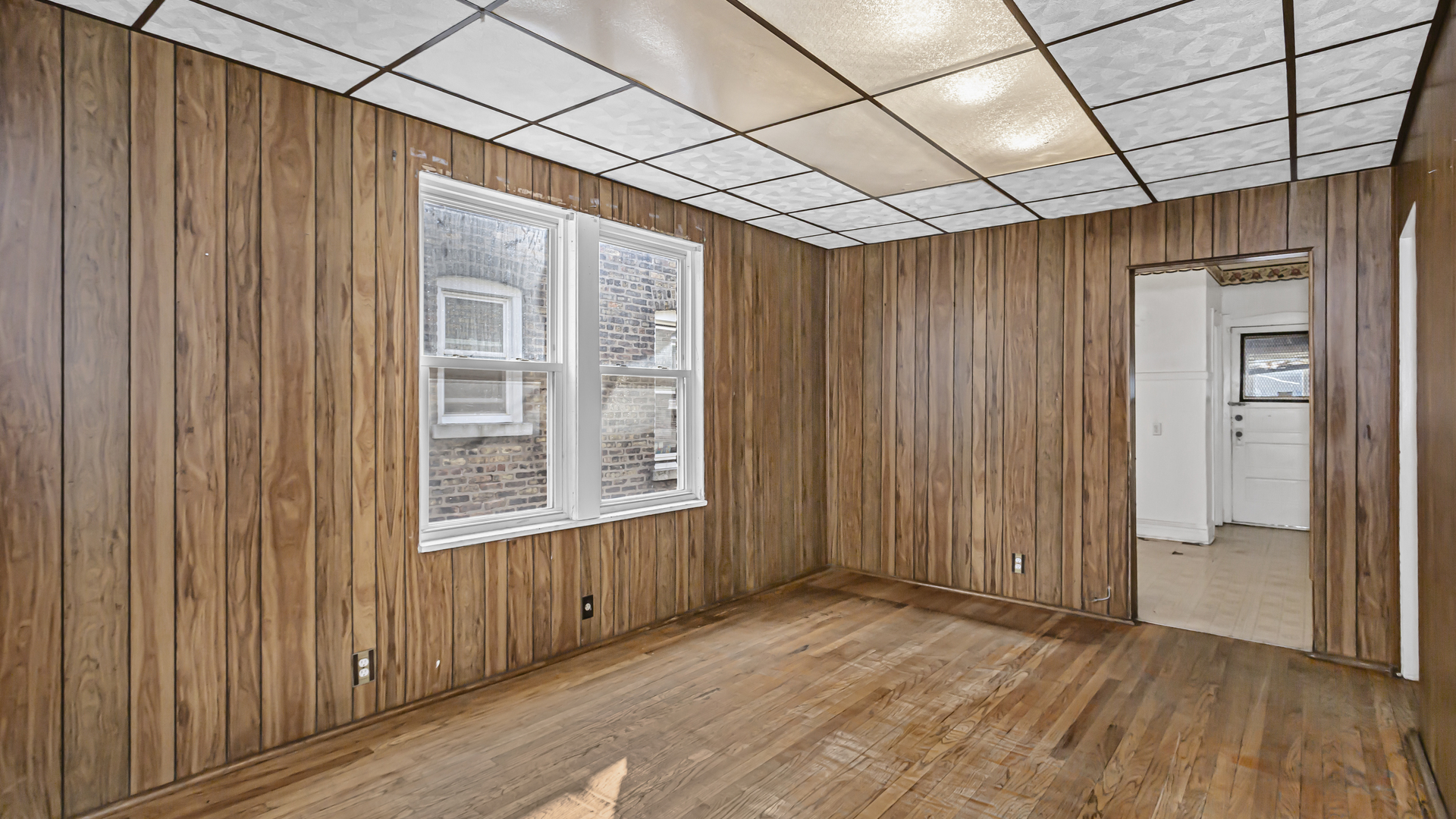 1712 North Monitor Avenue Chicago, IL 60639 - Photo 15 of 33 an empty room with wooden floor and windows