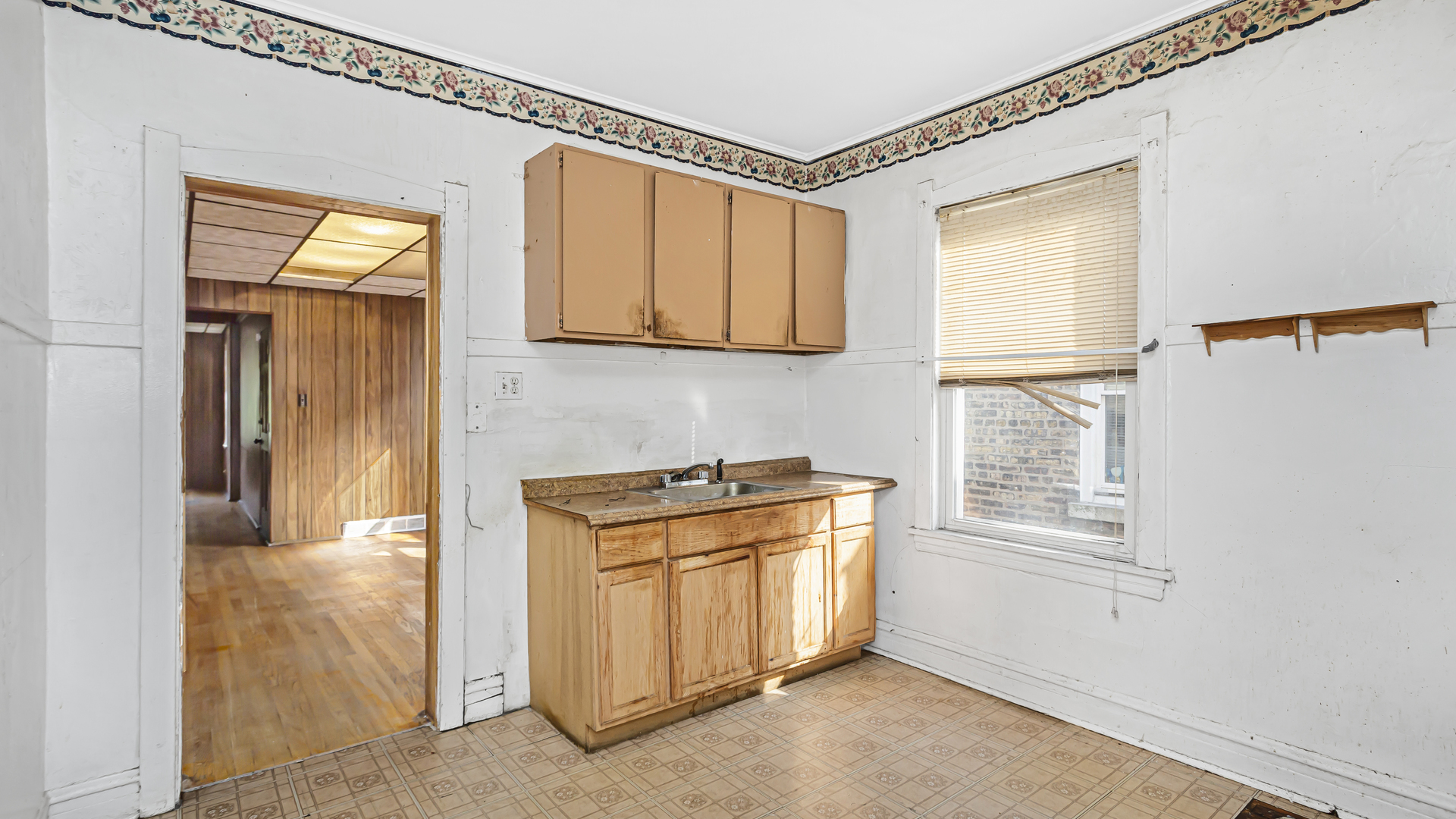 1712 North Monitor Avenue Chicago, IL 60639 - Photo 17 of 33 a kitchen with stainless steel appliances granite countertop cabinets and a window