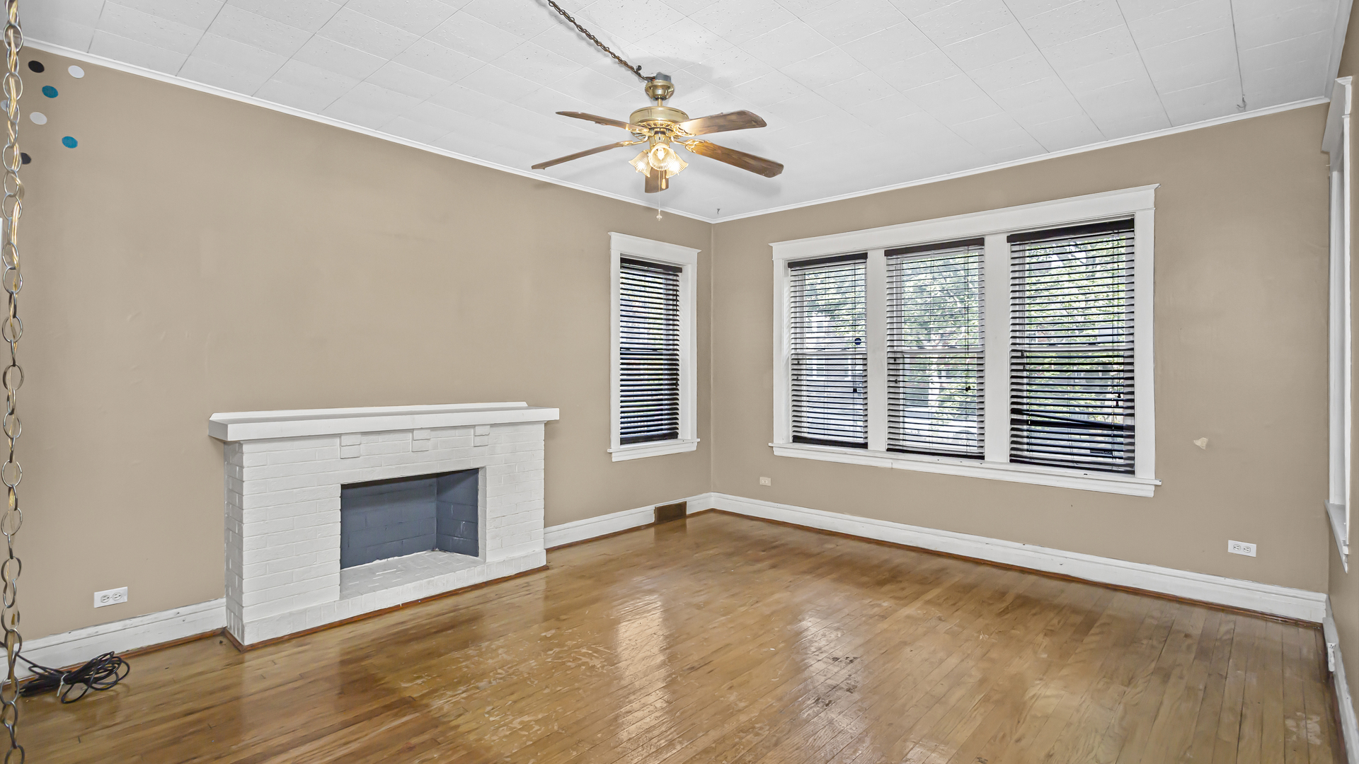 1712 North Monitor Avenue Chicago, IL 60639 - Photo 2 of 33 a view of an empty room with a fireplace and a window