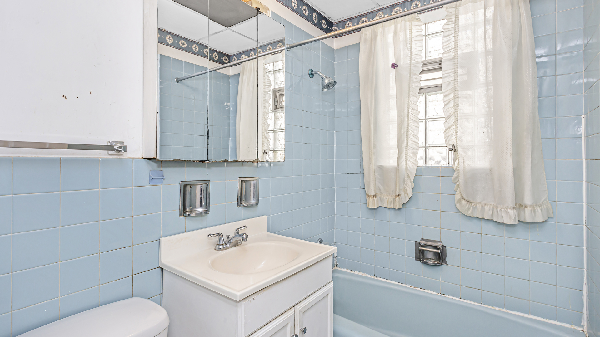 1712 North Monitor Avenue Chicago, IL 60639 - Photo 21 of 33 a bathroom with a sink toilet a mirror and shower