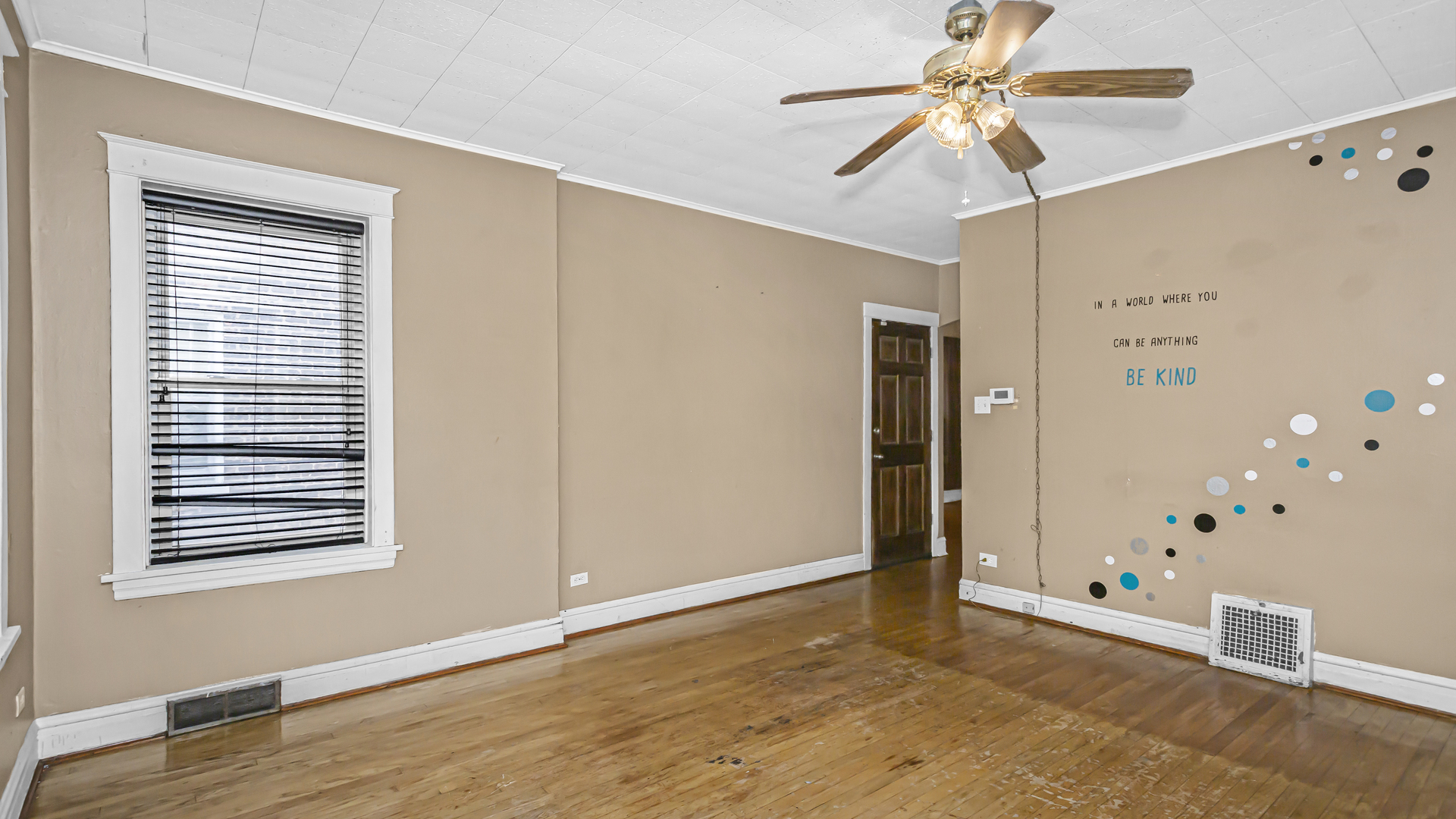 1712 North Monitor Avenue Chicago, IL 60639 - Photo 3 of 33 a view of an empty room with window and wooden floor