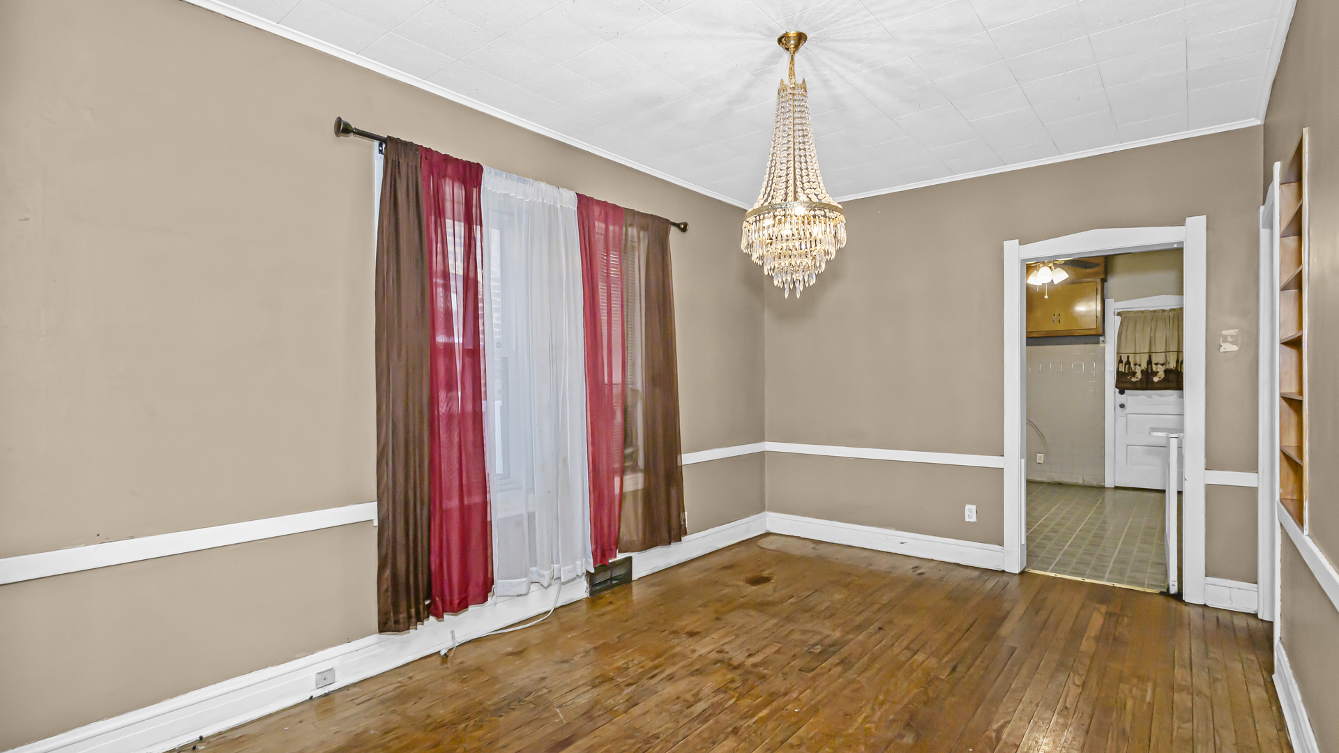 1712 North Monitor Avenue Chicago, IL 60639 - Photo 4 of 33 a view of a room with wooden floor and a chandelier