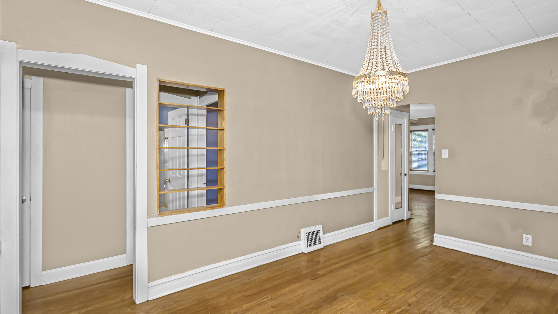 1712 North Monitor Avenue Chicago, IL 60639 - Photo 5 of 33 a view of a livingroom with a chandelier and wooden floor