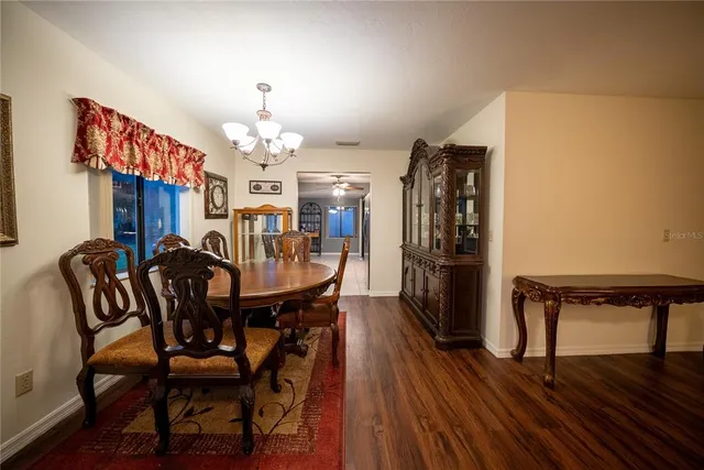 a view of a dining room with furniture and a chandelier