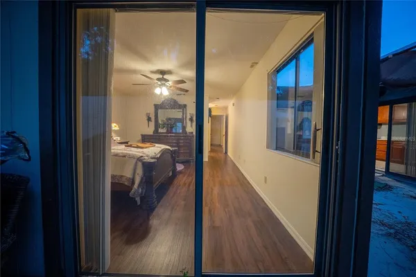 a view of a hallway with a livingroom and a bathroom with sink